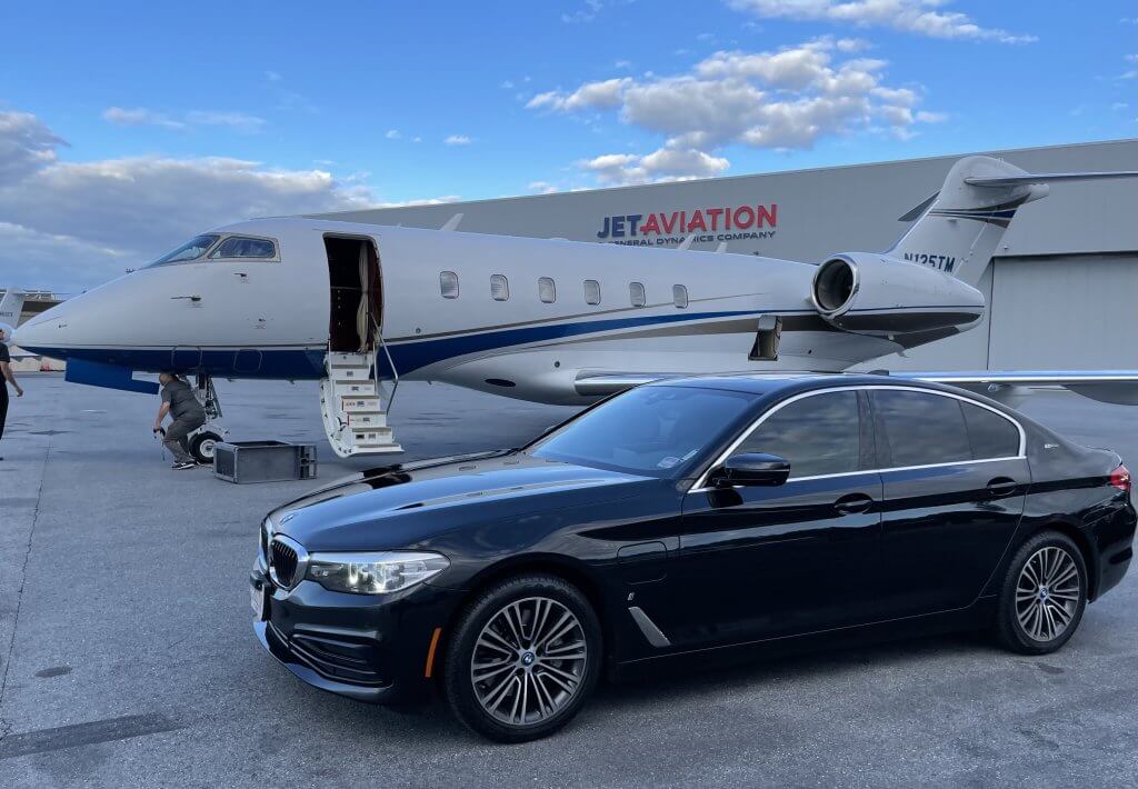 A bmw series 5 waiting at private jet at FBO airport.