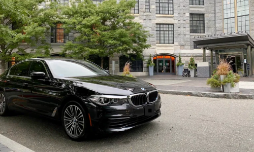 A black luxury car service BMW waiting for VIP passenger