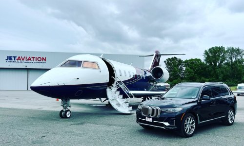 A bmw X7 waiting at private jet at FBO airport.